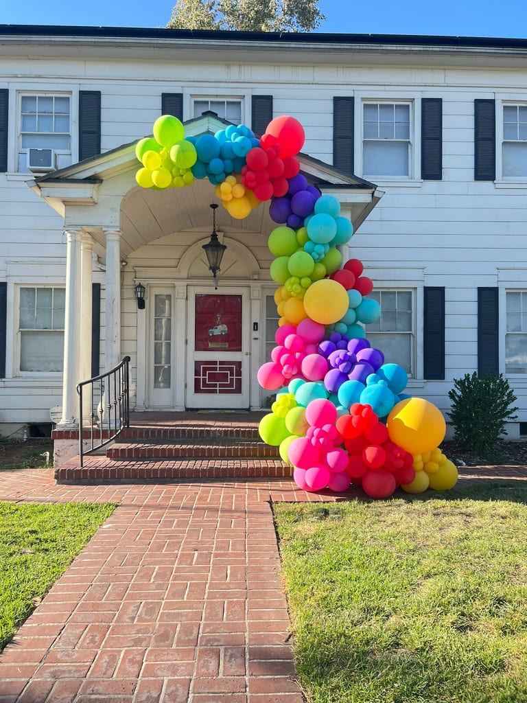 The Porch of a House Decorated with a Colorful Balloon Garland | Majestic Balloons | Cambridge, Ontario