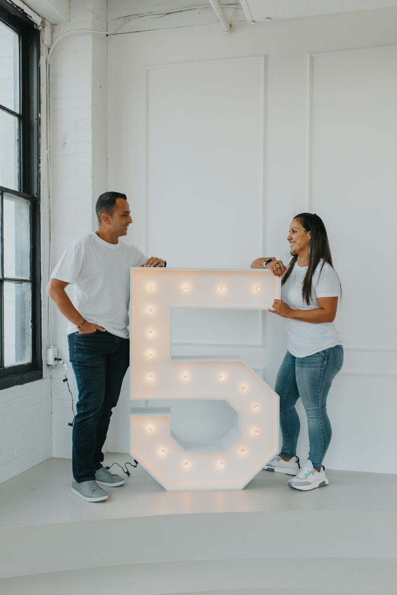 Marque Number 5 Between a Woman and a Man Smiling at Each Other | Majestic Balloons | Cambridge, Ontario